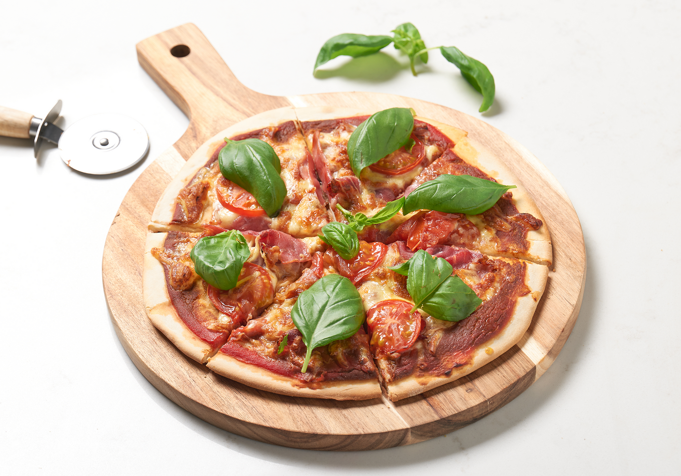 Proscuitto and basil pizza